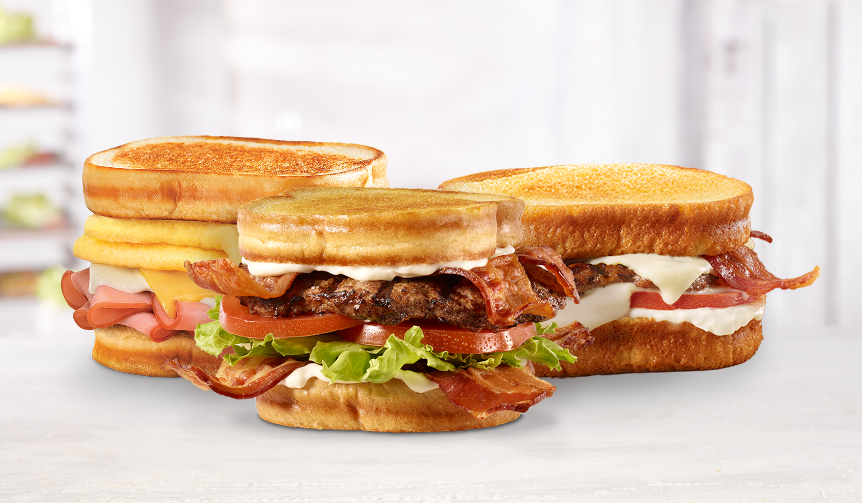hardee's frisco sandwich lineup with BLT frisco angus burger, original angus burger, and frisco breakfast sandwich 